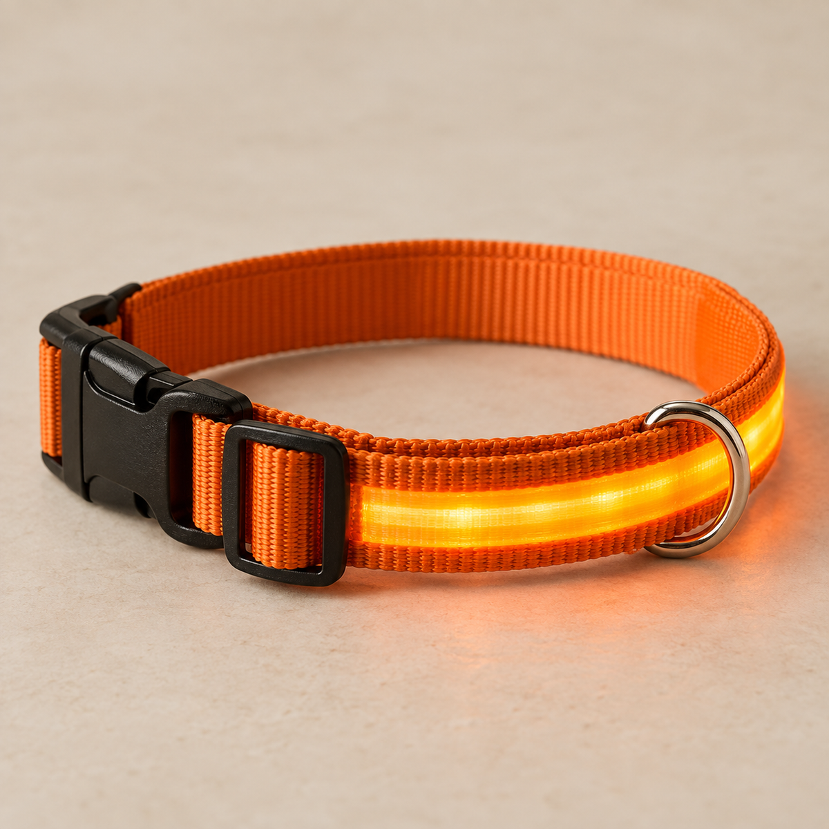 Orange LED dog collar on warm neutral surface