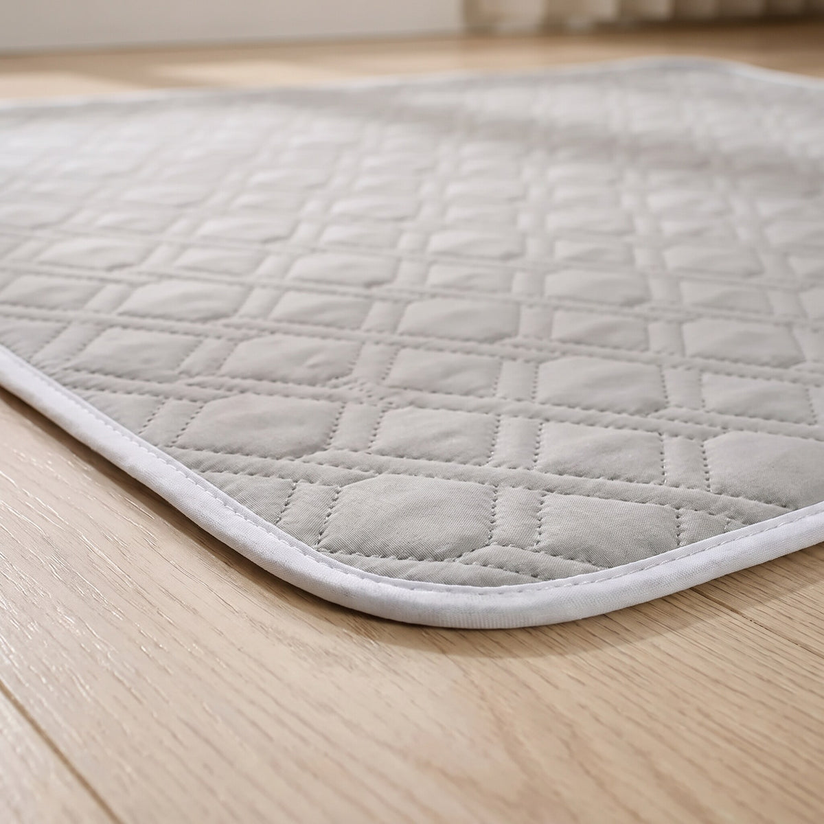 Close-up of the quilted top and bound edge of the washable pee pad