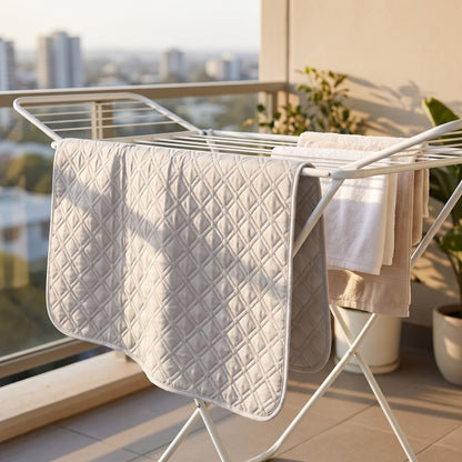 Washable pee pad drying on a clothes airer on a balcony