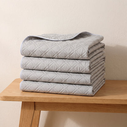 Four washable pee pads folded and stacked, the 4 pad pack